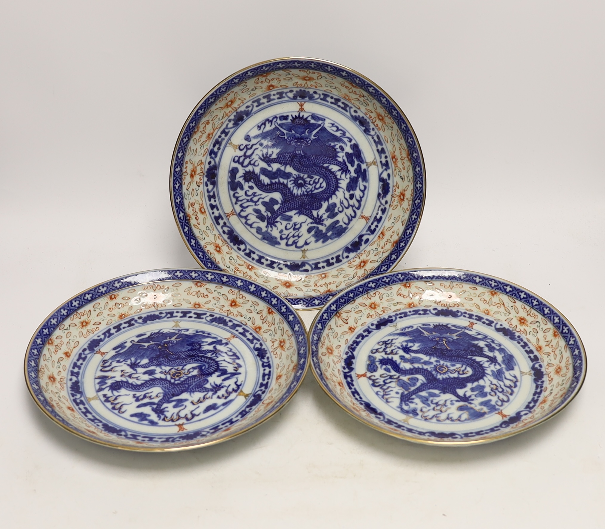 Three Chinese blue and white ‘dragon’ dishes, 24cm diameter
